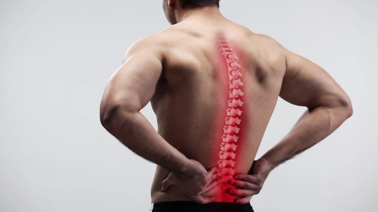 A man supporting his back due to back pain on Dr Back Mattress TV Commercial